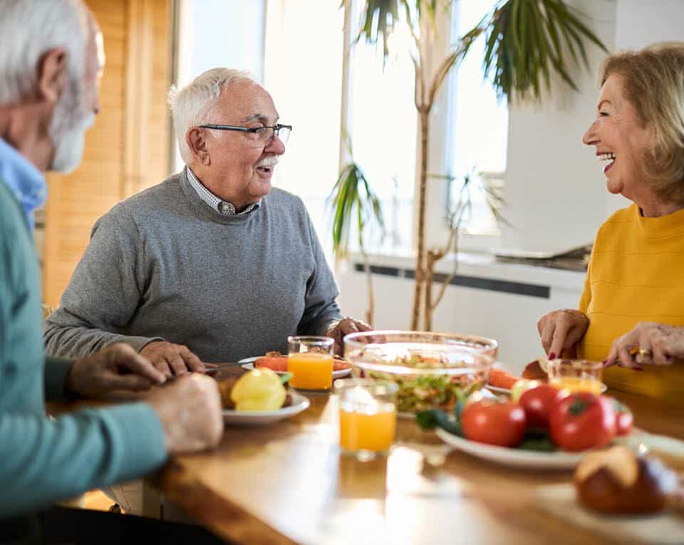 residents sharing stories and laughs over a meal