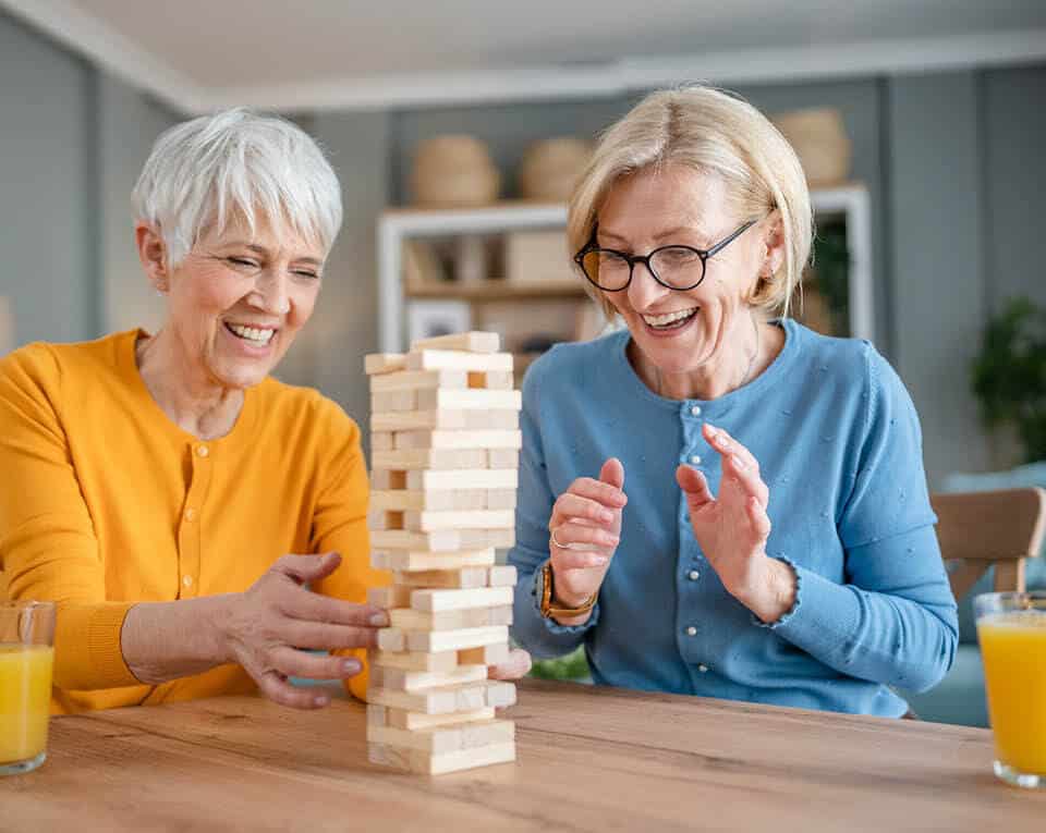 two female residents playing Jenga