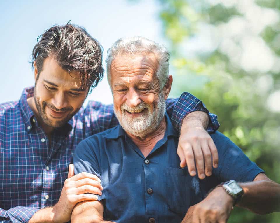 father and son talking and smiling