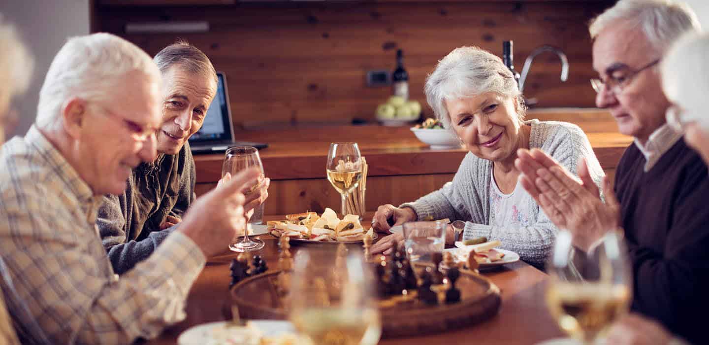 friends sharing stories and laughs over some wine and snacks