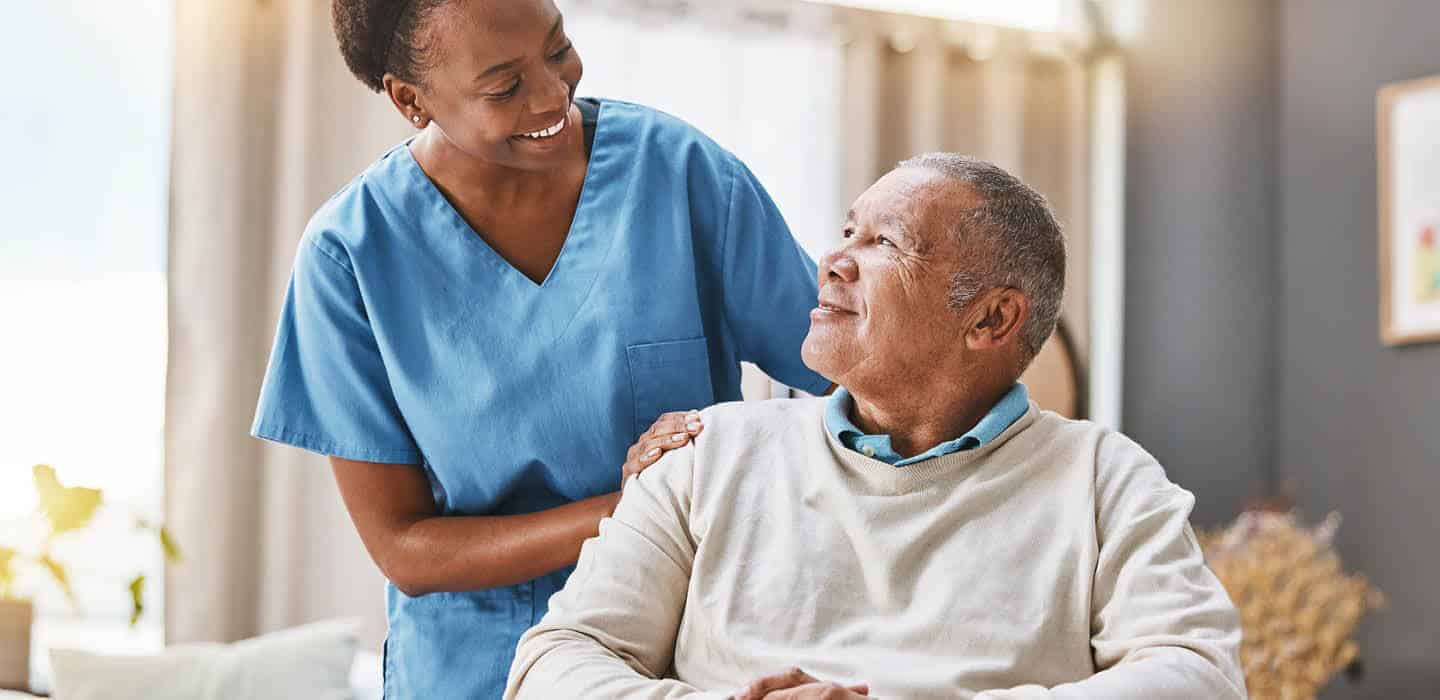 caring staff member talking to resident